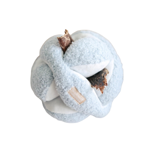 Detail view of treat slots in use in the Blue MONTI snuffle ball