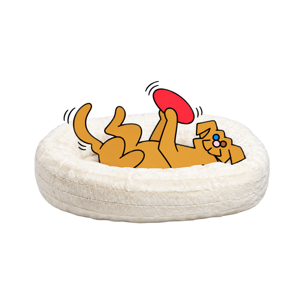 Bowsers Donut dog bed in cream with the illustrated Fetch dog lying belly-up and holding a red frisbee above him.